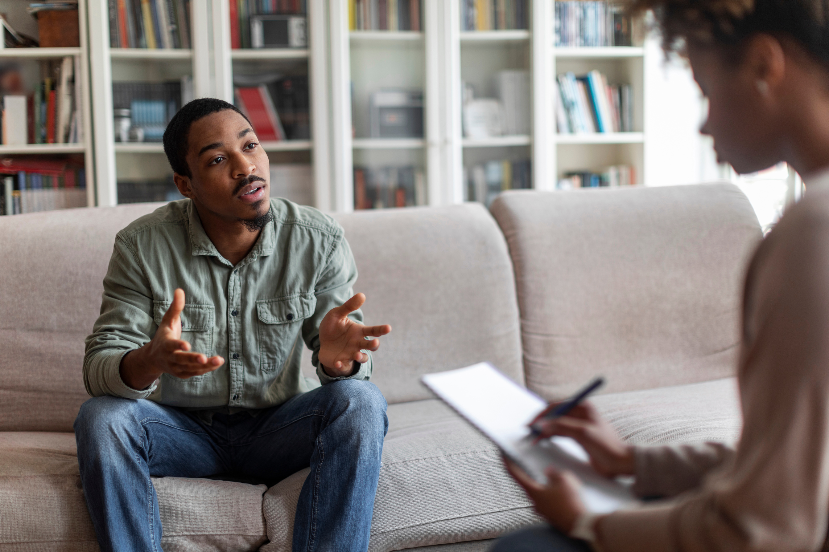 Emotional african american guy attend  session with psychologist